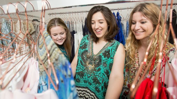 Customers pick through the racks at Dressed Up in the City, a fashion business that offers designer dress rentals.