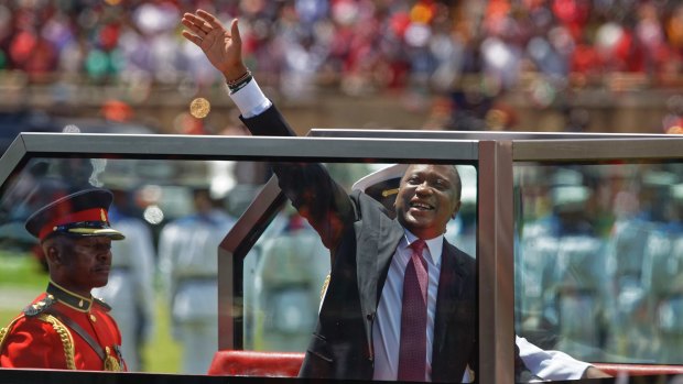 Kenyan President Uhuru Kenyatta waves from behind bulletproof glass as he arrives for his inauguration ceremony on Tuesday.