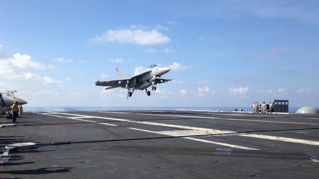 An FA-18 jet fighter lands on a US aircraft carrier in the South China Sea this month.