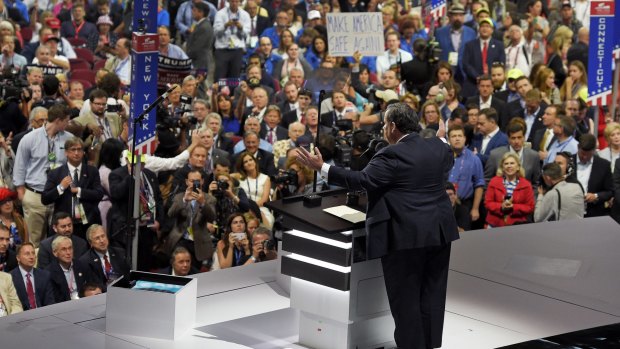 Chris Christie speaks while others chant.