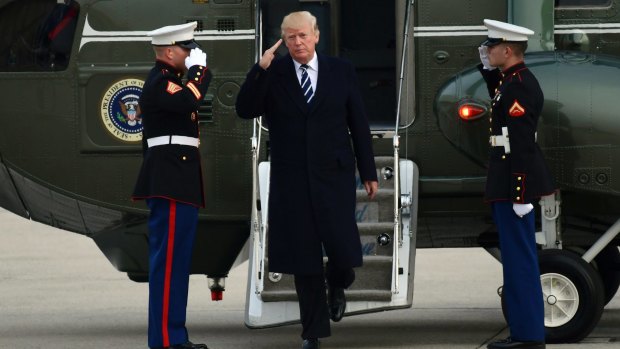 US President Donald Trump steps off Marine One at John F. Kennedy International Airport in New York on Saturday.