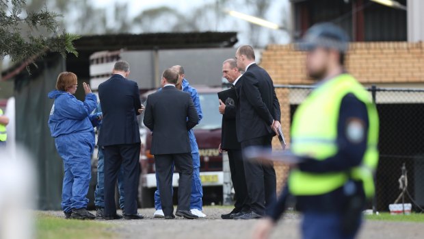 Police at Keith Cini's home in Badgerys Creek following his death in May: two men have been charged with murder.