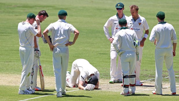 Adam Voges of the Warriors sinks to his knees after being struck in the head by a bouncer from Cameron Stevenson.
