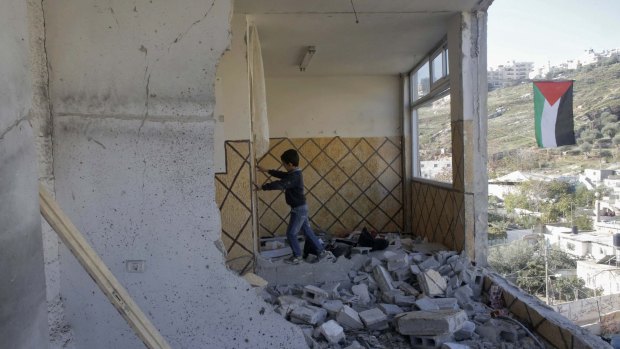 A relative of Abdel Rahman al-Shalodi inside the demolished family home in the occupied East Jerusalem neighbourhood of Silwan.