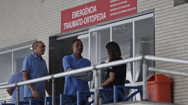 Employees stand in front an emergency entrance at the Souza Aguiar Hospital in Rio de Janeiro after the shooting.