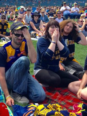 Frustrated West Coast Eagles fans at Domain Stadium watch their team's demolition in disbelief.