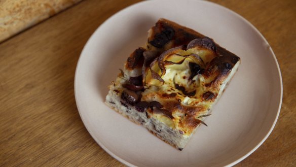 A delicious slice of potato and olive focaccia.