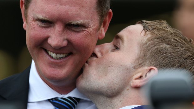 Puckered up: Tommy Berry with trainer Michael Hawkes.