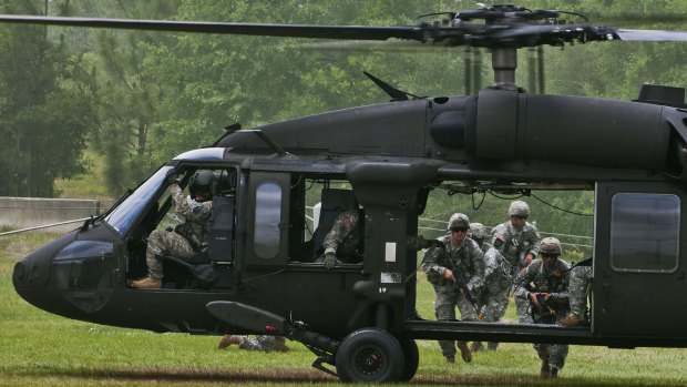 US Army Rangers make their way to a UH-60 Black Hawk at Eglin Air Force Base, Florida.  Seven US Marines and four aircrew were missing on Wednesday after a Black Hawk crashed during a training exercise in Florida. 
