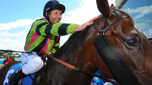 Damien Oliver pats Suavito after winning the Futurity Stakes on Saturday.