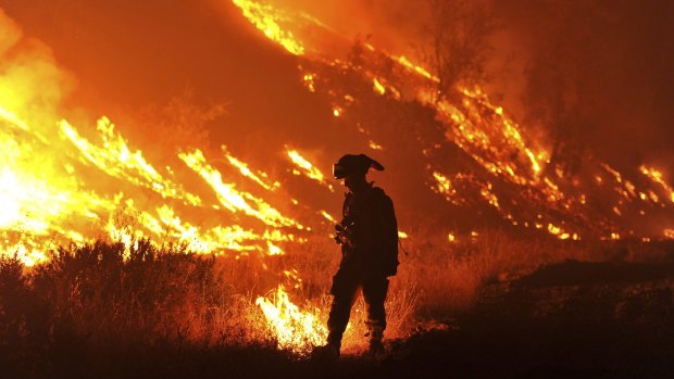 CalFire firefighter Bo Santiago lights a backfire as the Rocky fire burns near Clearlake, California.