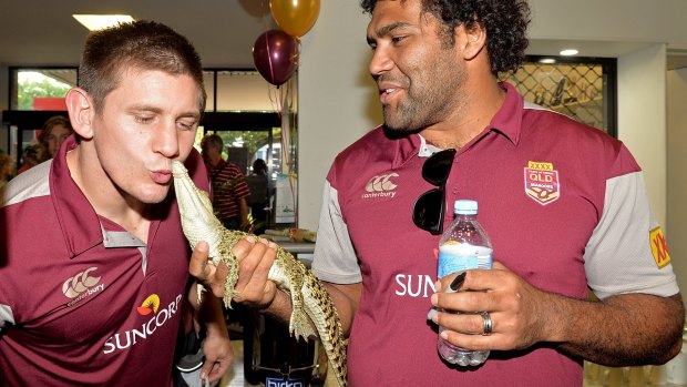 PROSERPINE, AUSTRALIA - JUNE 30: Sam Thaiday holds a baby crocodile as Jacob Lillyman gives it a kiss during the Queensland Maroons State of Origin fan day on June 30, 2015 in Proserpine, Australia.  (Photo by Bradley Kanaris/Getty Images)