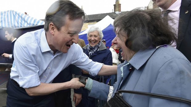 Britain's Prime Minister David Cameron greets locals during a 'walkabout' whilst campaigning in Wetherby in northern England on Thursday.