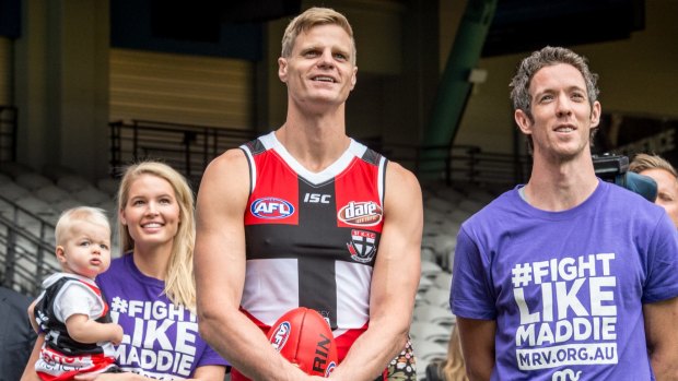 On a mission: St Kilda captain Nick Riewoldt with Bulldogs captain Bob Murphy and his wife Catherine and son James.