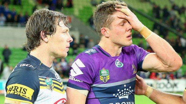 Rory Kostjasyn of the Cowboys consoles Matt Duffie of the Storm after the Cowboys defeated the Storm.