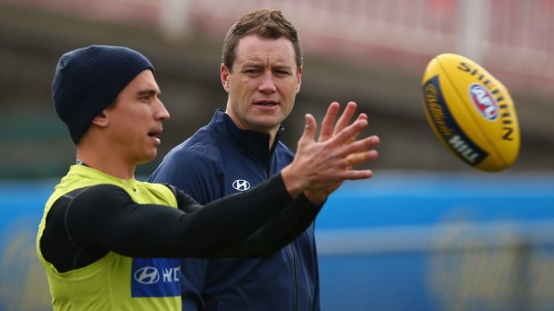Blues coach John Barker talks to Andrew Carrazzo during a training session.