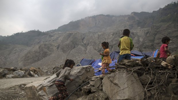 Nepalese children run next to their makeshift shelter near a landslide area after the April 25 earthquake at Jure village in Sindhupalchowk, Nepal. Areas of Nepal remain perilously unstable.