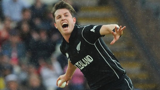 New Zealand's Adam Milne celebrates the dismissal of Australia's Moises Henriques as the rain falls at Edgbaston.