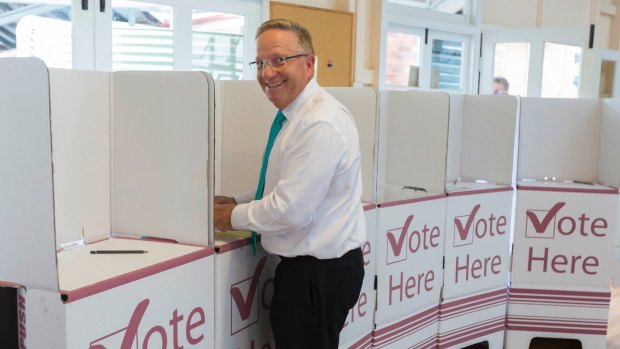 Former Australian cricketer Ian Healy casts his vote at East Brisbane State School.
