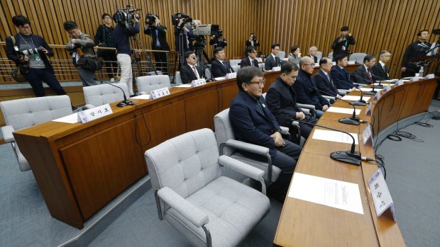 The empty seat, bottom right, of Choi Soon-sil, who is accused of colluding with South Korean President Park Geun-hye to control government affairs and extort companies, is seen during a hearing at the National Assembly in Seoul, South Korea, Wednesday December 7. 