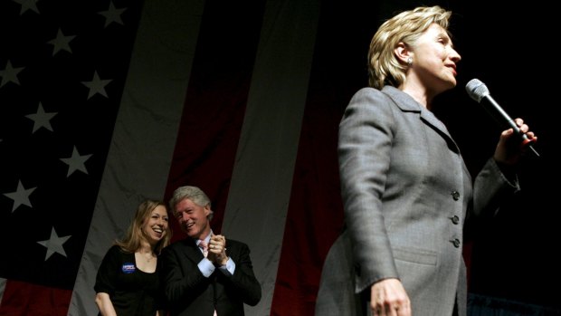 Former US president Bill Clinton and daughter Chelsea listen as presidential candidate Senator Hillary Clinton speaks at a fundraising rally in New York.