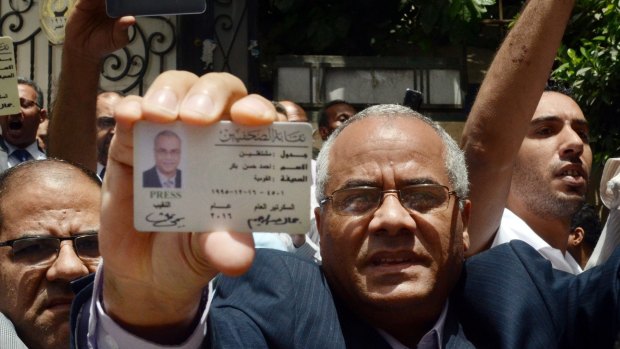 Egyptian-American journalist Ahmed Bakr shows his ID as he and others are blocked from entering a protest near the Press Syndicate in Cairo earlier this month.