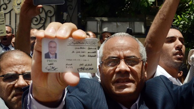 Egyptian-American journalist Ahmed Bakr shows his ID as he and others are blocked from entering a protest near the Press Syndicate in Cairo earlier this month.