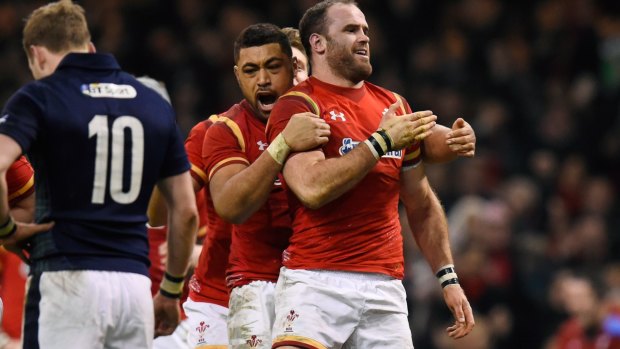 Jamie Roberts is congratulated by teammate Taulupe Faletau  after scoring his team's second try.