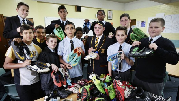 Good cause: Students from Champagnat College with the footy boots that will go to indigenous communities.
