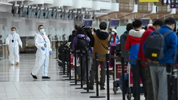Passengers line up to check in for an international flight at Pearson International Airport in Toronto. 