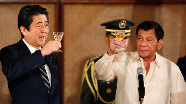Japanese Prime Minister Shinzo Abe, left, and Philippine President Rodrigo Duterte toast during a state banquet at the Malacanang Palace in Manila, before visiting Mr Duterte's hometown of Davao.