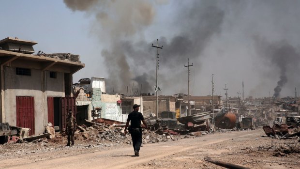 Smoke rises during heavy fighting between Islamic State militants and Iraqi special forces in west Mosul.