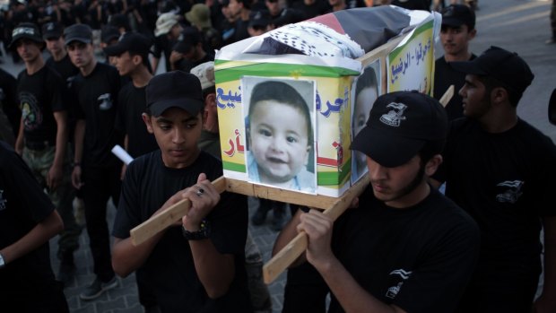 Palestinian youths carry a mock coffin of Ali Dawabshe in the Gaza Strip town of Khan Younis.