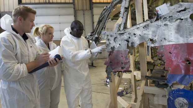 An Australian forensic team examines a piece of MH-17 in Holland in March.