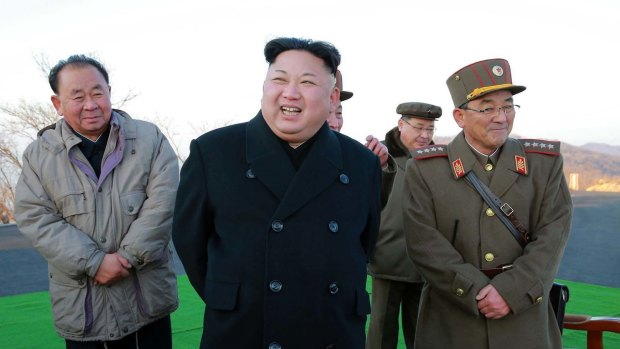 Kim Jong-un, centre, smiles during a missile launch in March.