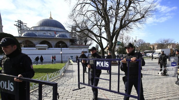Police officers install security barriers around the Blue Mosque at the historic Sultanahmet district of Istanbul after an explosion on Tuesday.