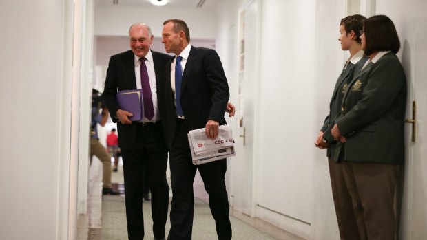 Former deputy prime minister Warren Truss and Mr Abbott arrive for the joint party room meeting.