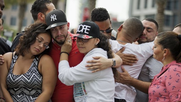 Mourners console each other at a vigil in Orlando after the mass shooting at the Pulse nightclub.