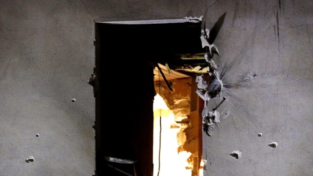 Bullet holes are pictured around a window on the back side of the house after an intervention of security forces against a group of Islamists in Saint-Denis on Wednesday. 