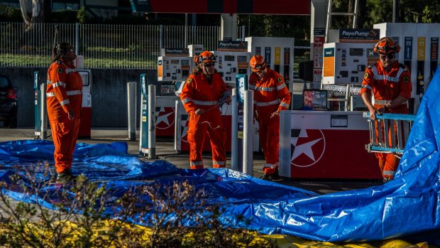 Tarpaulin sheeting was set up around the service station. 