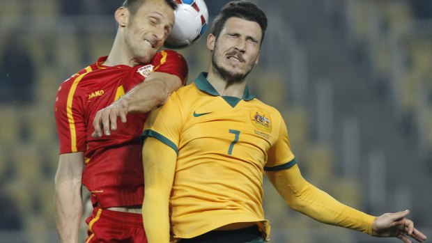 Committed: Mathew Leckie goes shoulder-to-shoulder with Macedonia's Artim Polozhani.