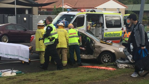 Emergency crews work to free a woman trapped in a car on the Gold Coast.