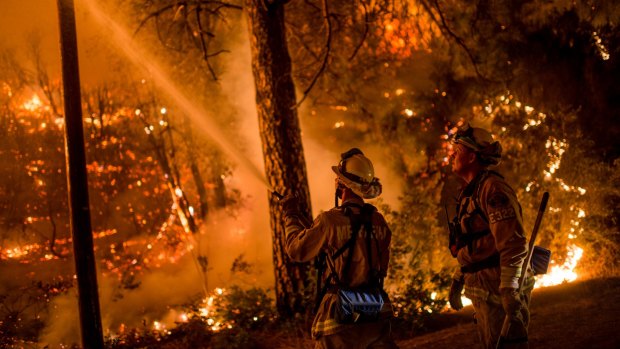 Fire crews run night operations and controlled burnings to contain a wildfire in Sheep Ranch, California on the weekend.
