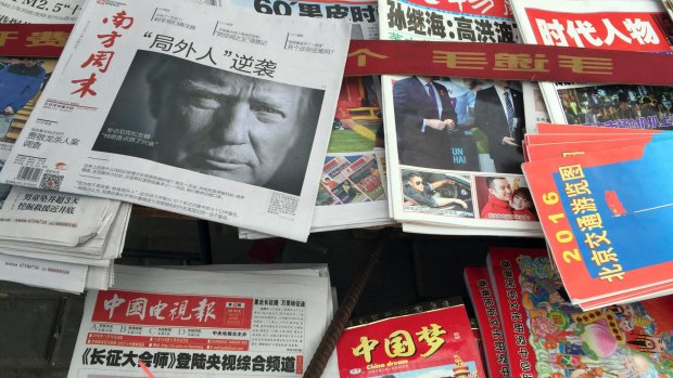 A front page of a Chinese newspaper with a photo of Donald Trump and the headline "Outsider counter attack" is displayed at a news stand in Beijing on Thursday.