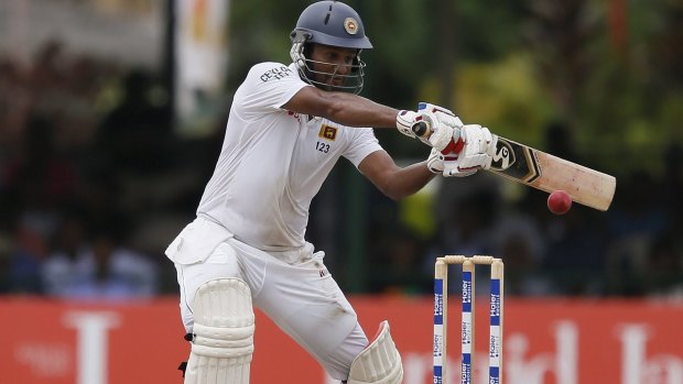 Sri Lanka's Dimuth Karunaratne pats down a rising delivery during his innings of 50 which helped his team to a seven-wicket win on Monday.