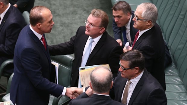 Mr Dutton is congratulated by colleagues after introducing the bill.