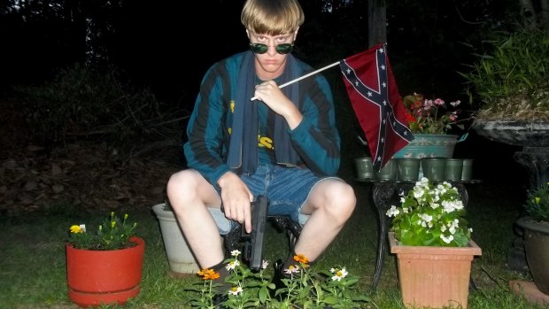 This undated image of Roof waving a confederate flag that appeared on a website being investigated by the FBI.