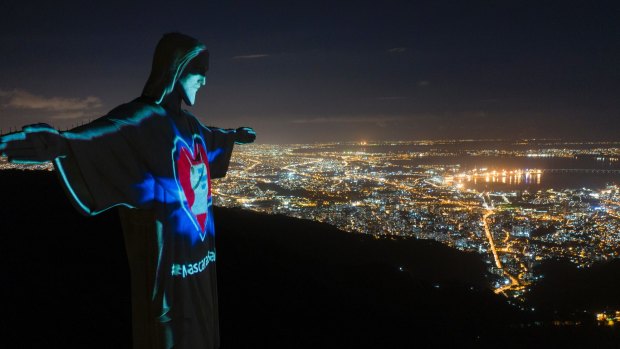 Rio's Christ the Redeemer statue is lit up as if wearing a protective mask amid the new coronavirus pandemic.