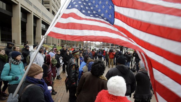 People protest outside the Cuyahoga County Justice Centre, Cleveland, on Tuesday.