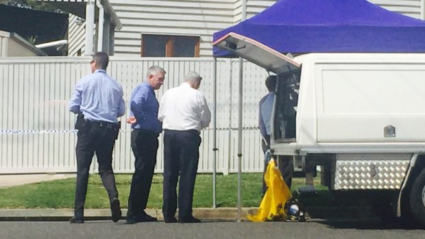 Police at the Kedron home where the girl was found dead in September.